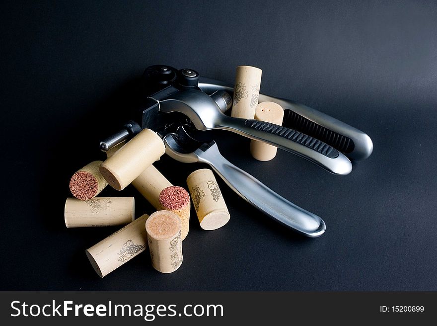 Sophisticated cork lifter with group of taken out wine cork. Sophisticated cork lifter with group of taken out wine cork