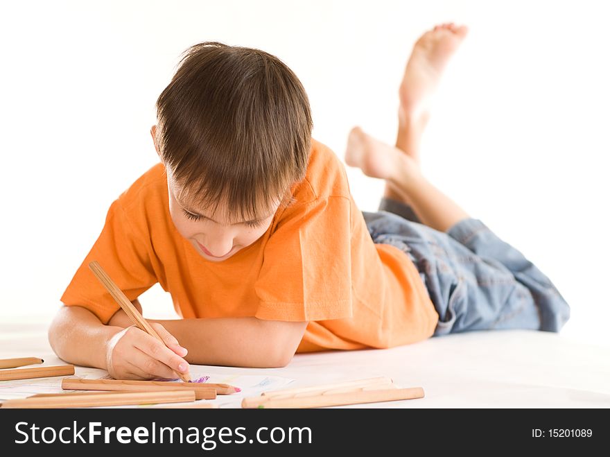 Boy lying on the floor and draw. Boy lying on the floor and draw