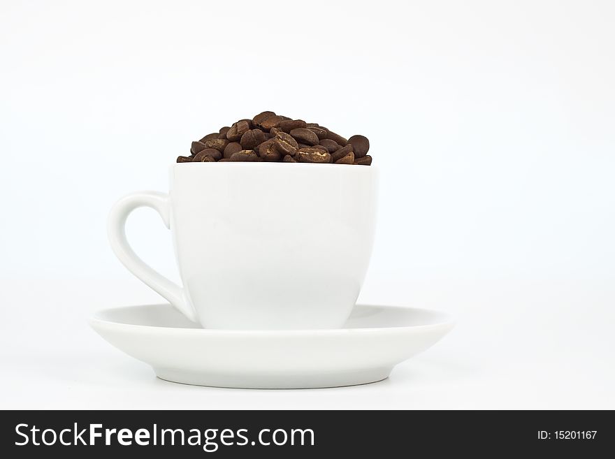 White coffee cup with plat eand coffee beans on white background