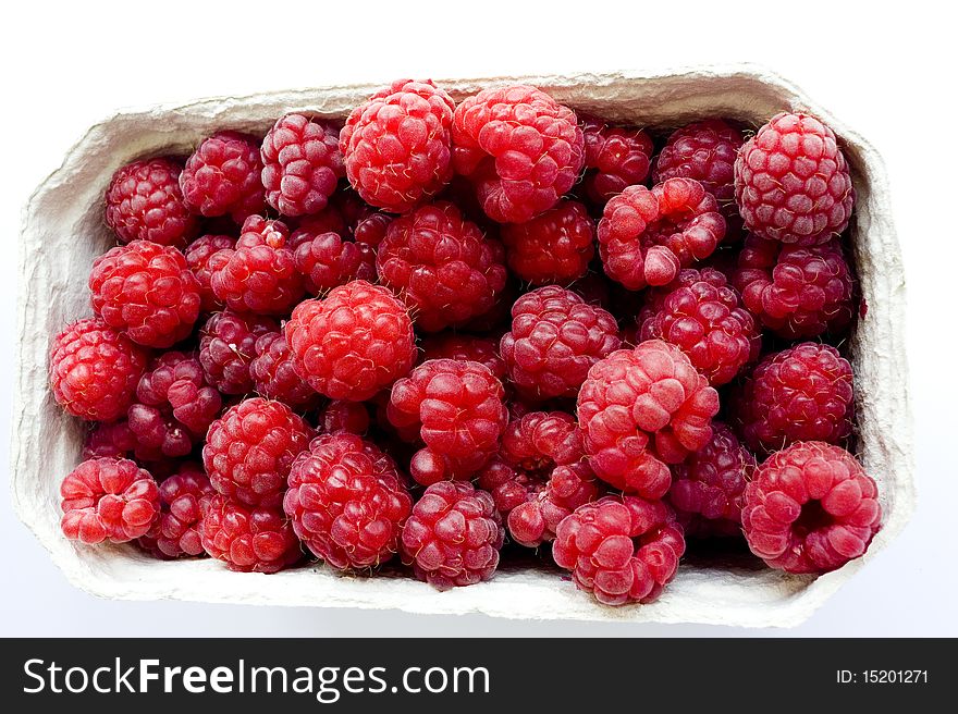 Fresh raspberries collected in paper container. Fresh raspberries collected in paper container