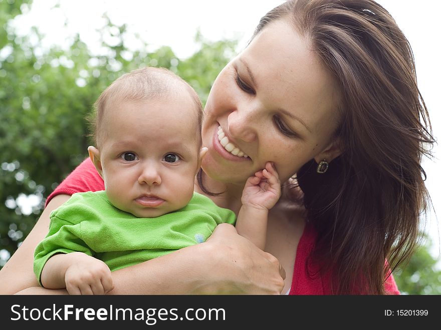 Newborn in the arms of mother nature on the background