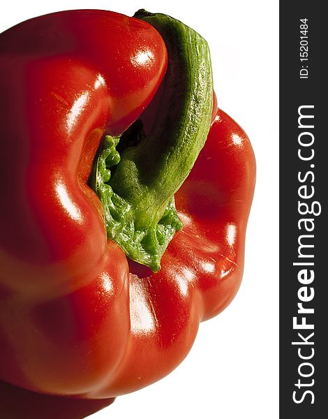 A closeup on a red bell pepper from the side, on white background and with copy space. A closeup on a red bell pepper from the side, on white background and with copy space.