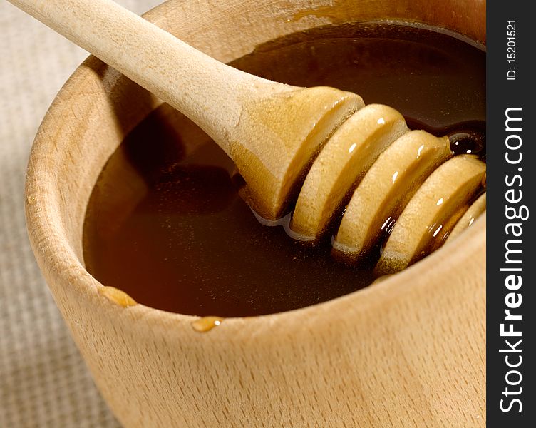 Honey in the wooden bowl with spoon