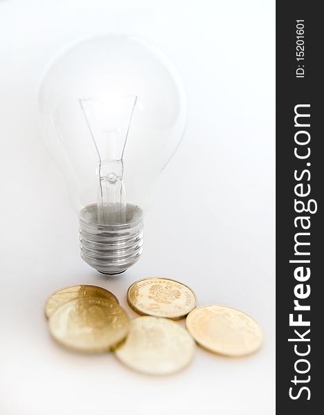 Bulb on isolated background with money. Bulb on isolated background with money.