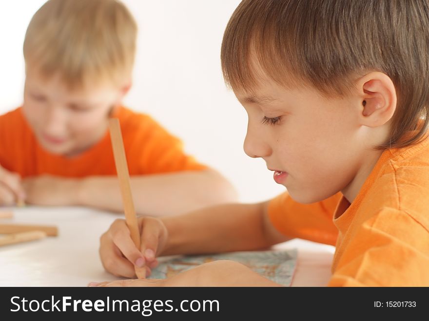 Two brothers paint on a white background