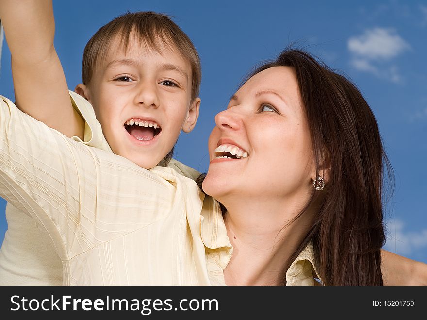 Happy woman with son on a background of sky. Happy woman with son on a background of sky