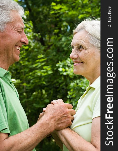 Happy elderly couple in a summer park