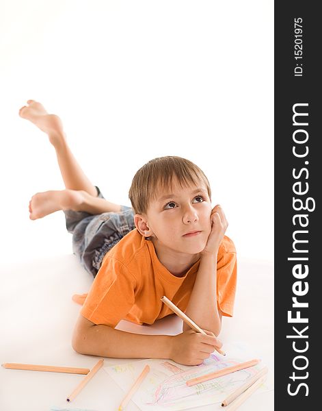 Boy lying on the floor and draw