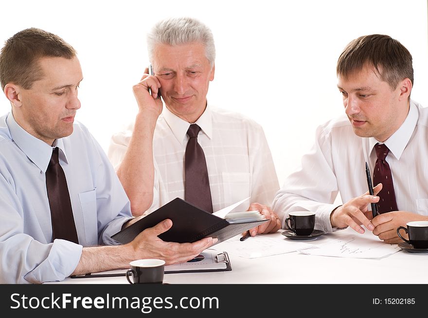 Three businessmen working on a white background