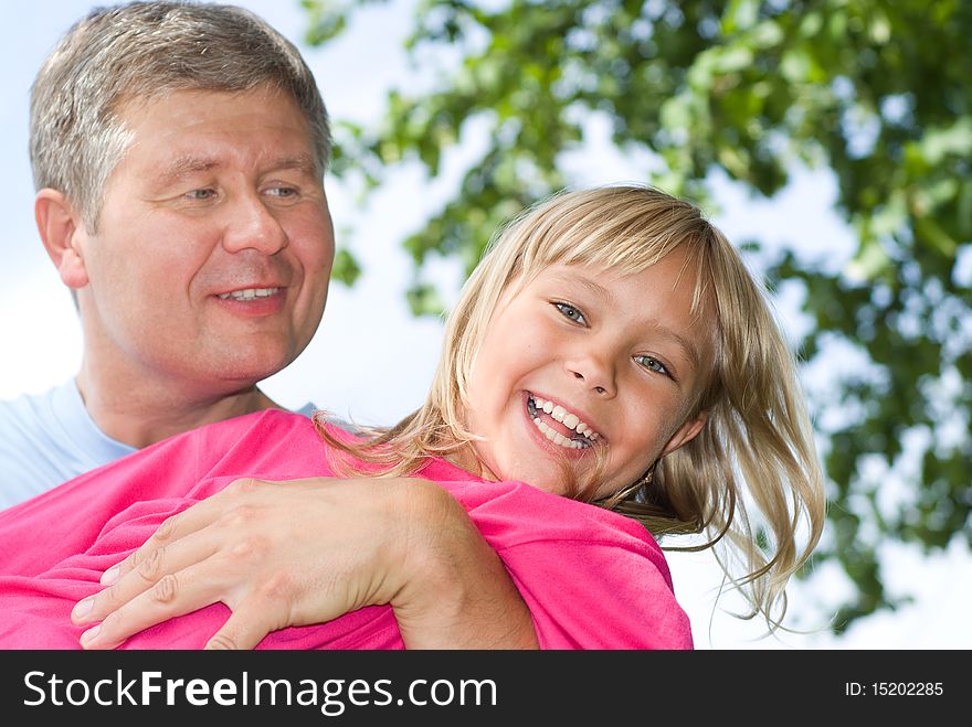 Happy father and daughter in summer park