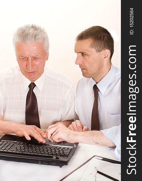 Two businessmen working together on a white