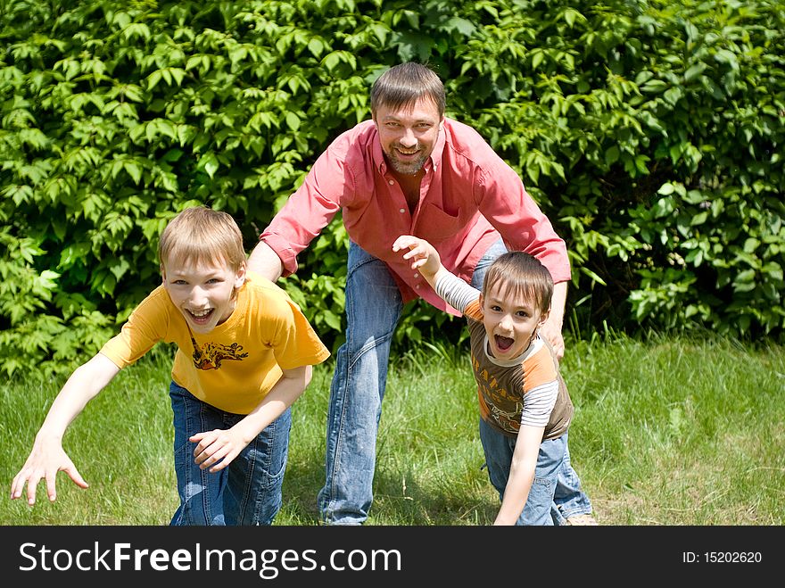 Father playing with  two children on nature. Father playing with  two children on nature