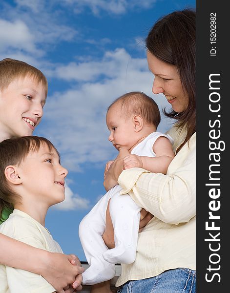 Young mother with three children standing together