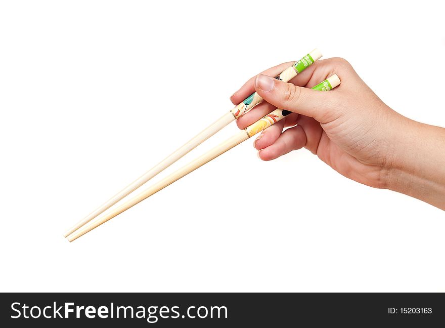 Female hand holding chopsticks on white. Female hand holding chopsticks on white