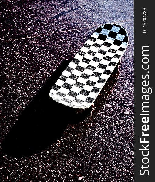 Skateboard placed on tile on outside