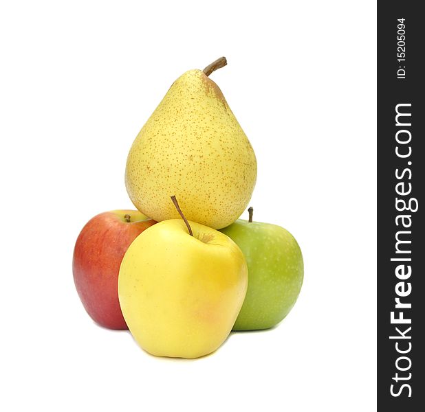 Pear balances on top of three apples. Pear balances on top of three apples