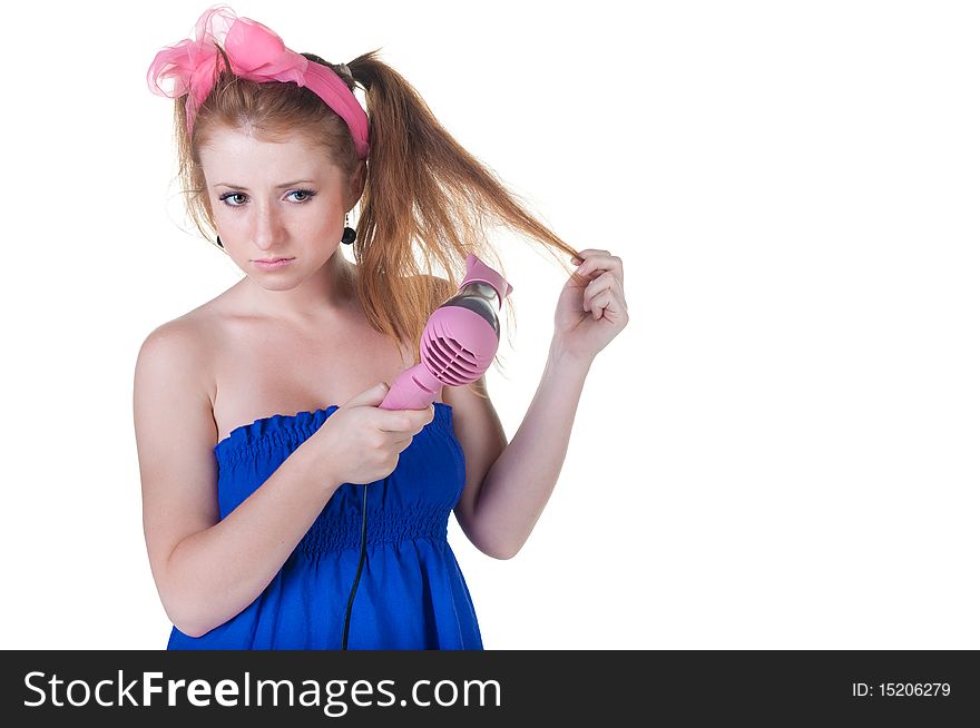 Red-haired girl with the hair dryer. Isolated over white .