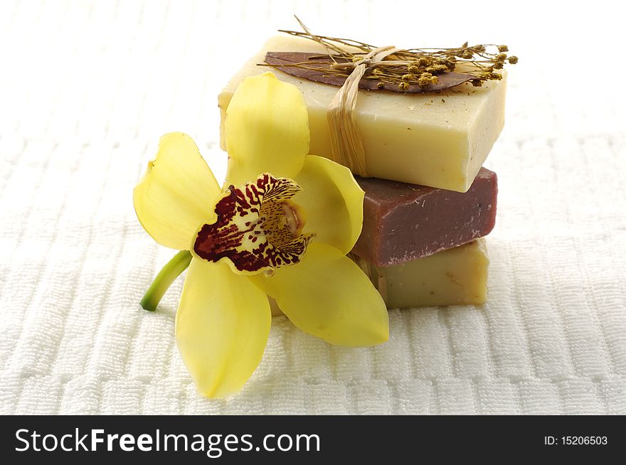 Spa soap with orchid on towel
