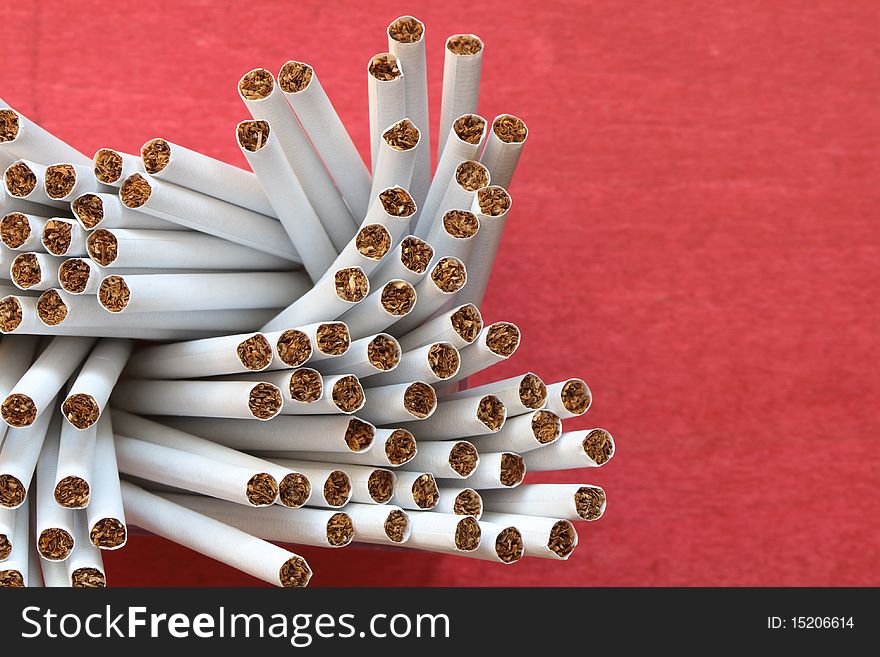 A lot of cigarettes on red background with copy space