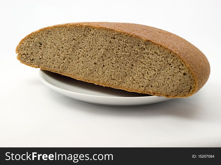 Bread on a plate on a white background. Bread on a plate on a white background