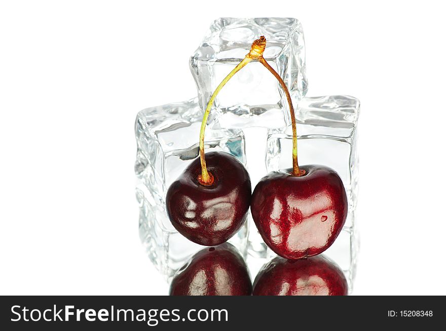 Fresh berries and cubes of ice on white background