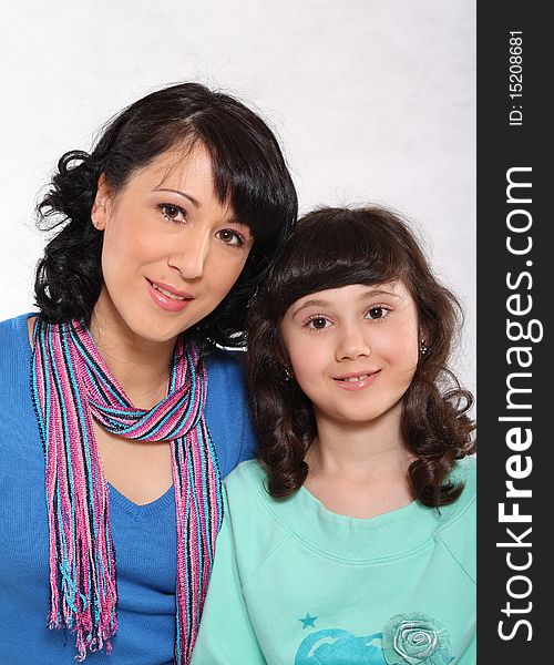 Portrait of mum and the daughter on a light background. Portrait of mum and the daughter on a light background