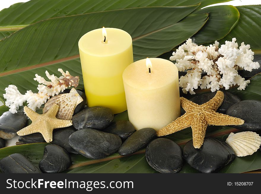 Spa setting- pebbles, candles ,shell and palm leaf