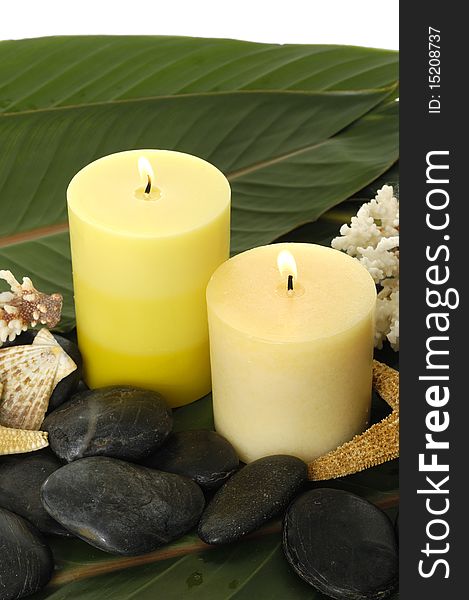 Spa setting- pebbles, candles ,shell and palm leaf