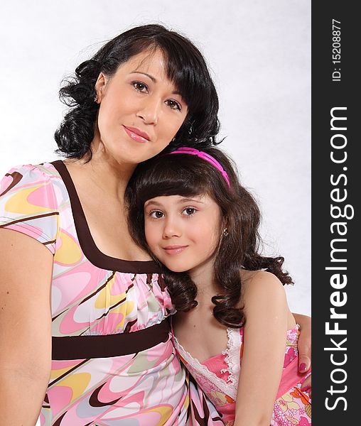 Mum and the daughter with tender feelings in pink dresses. Mum and the daughter with tender feelings in pink dresses