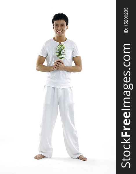 Isolated young man holding a fern