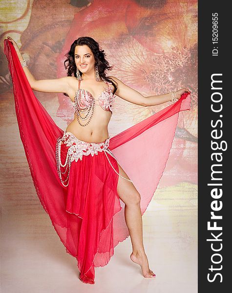 Beautiful belly dancer in motion isolated on bright background. Beautiful belly dancer in motion isolated on bright background