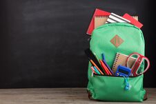 Education Concept - School Backpack With Books And Other Supplies, Blackboard Background Stock Photography