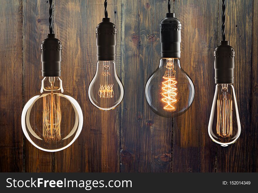 Vintage bulbs on wooden background - idea, innovation, teamwork and leadership concept. Space for text