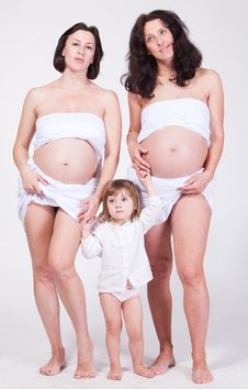 Two Happy Pregnant Women Keep The Cute Child Stock Photography