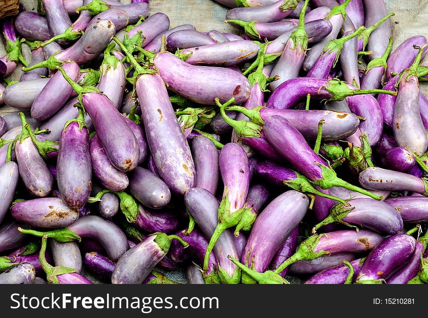 Eggplant at a market stall - often called Chinese eggplant or Japanese eggplant - common variety found throughout Asia. Eggplant at a market stall - often called Chinese eggplant or Japanese eggplant - common variety found throughout Asia