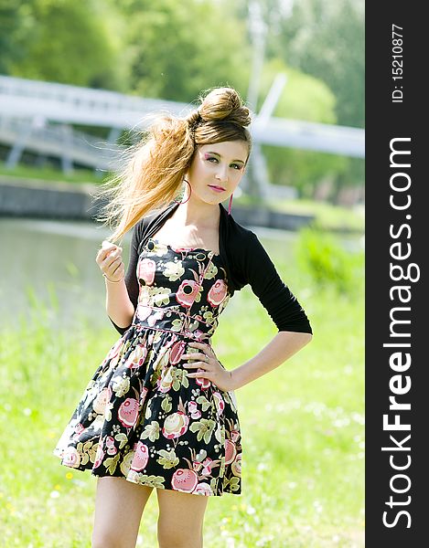 Teenager girl model presenting clothes in the park