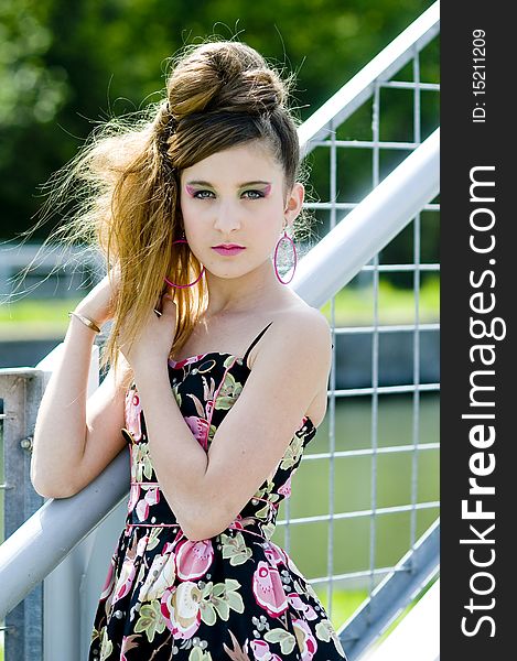 Teenager girl model presenting clothes in the park