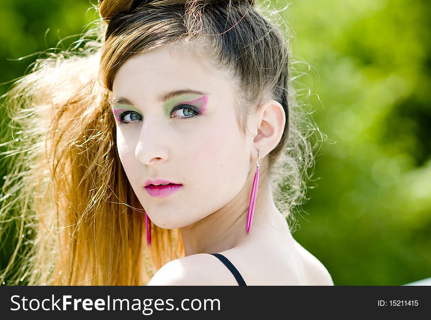 Closeup teenage girl model presenting clothes in the park natural background. Closeup teenage girl model presenting clothes in the park natural background