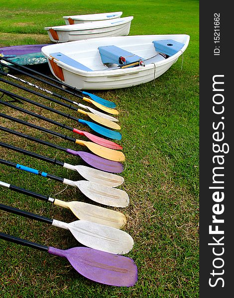 White Boat and colorful oars in garden. White Boat and colorful oars in garden