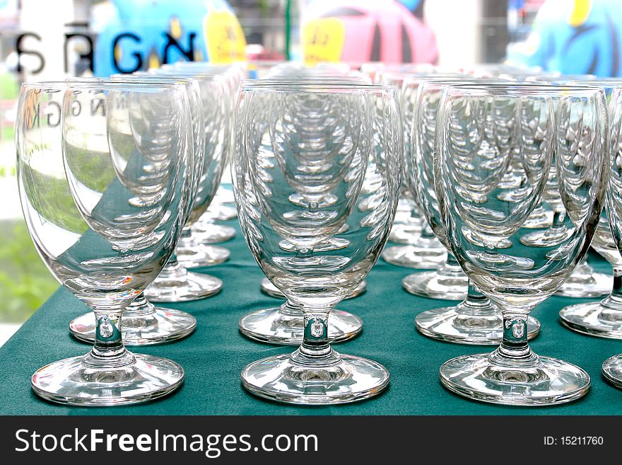 Several white wine glasses on table