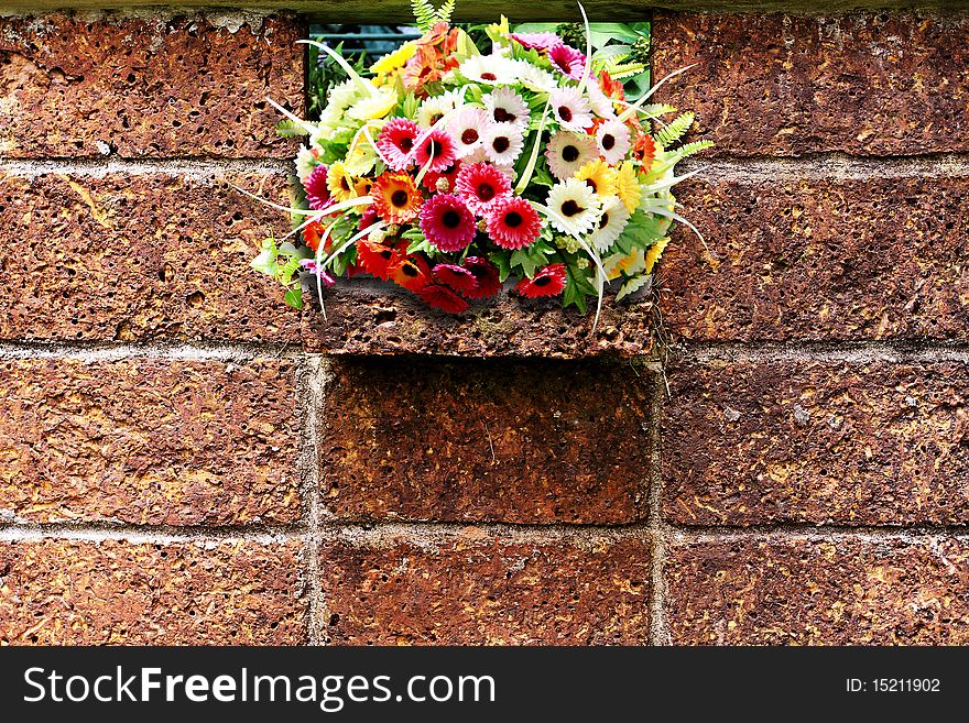 Stone background wall with colorful flowers