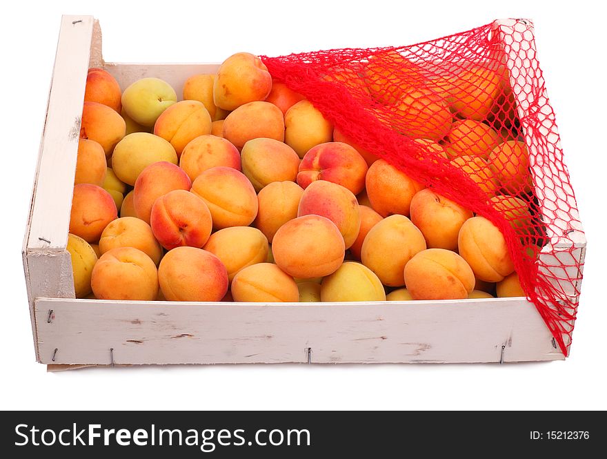 Box of apricots in the supermarket on a white background. Box of apricots in the supermarket on a white background