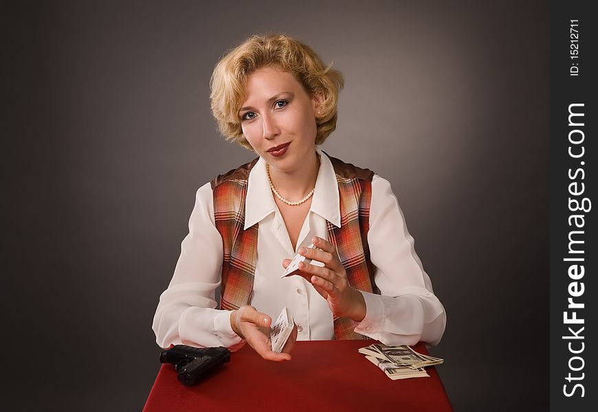 The pretty woman with cards on a grey background