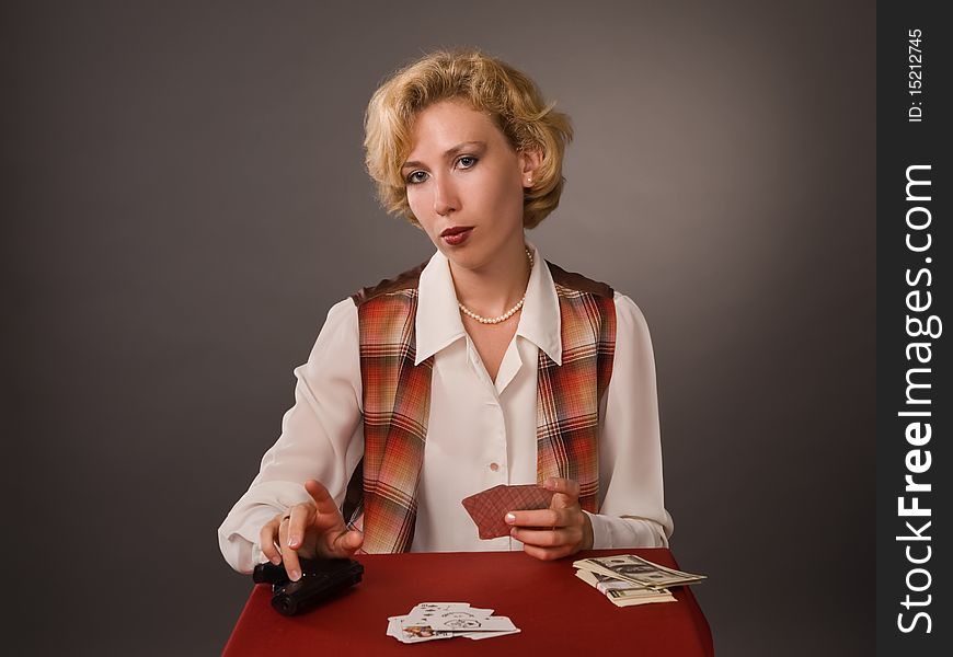 The pretty woman with cards on a grey background