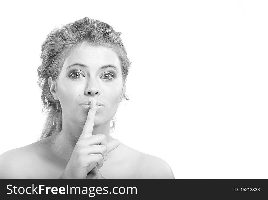 Monochrome closeup portrait of beautiful elegant woman with large grey eyes put her finger to lips. Monochrome closeup portrait of beautiful elegant woman with large grey eyes put her finger to lips
