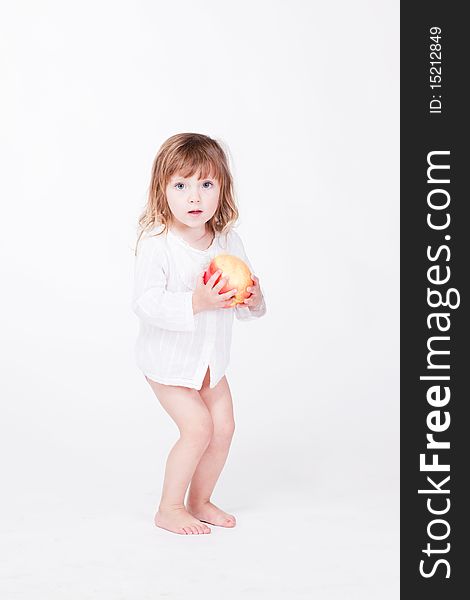 Studio porrait of cute child standing with apple at hands