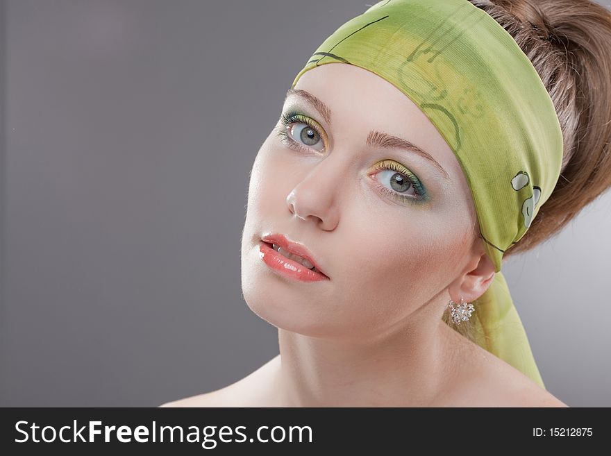 Closeup portrait of young woman with beautiful green eyes and colored scarf on head. Closeup portrait of young woman with beautiful green eyes and colored scarf on head