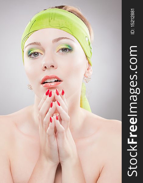 Closeup portrait of young woman with beautiful eyes holding hands near face