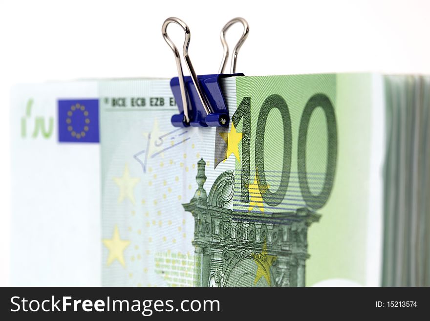 Euro banknotes with binder clip on white background