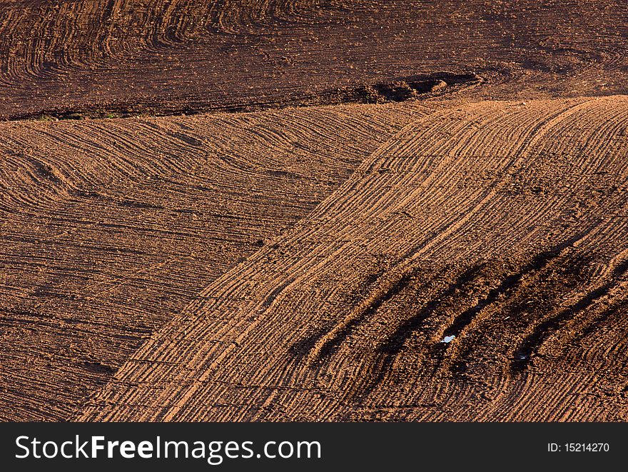 The freshly ploughed brown field. The freshly ploughed brown field